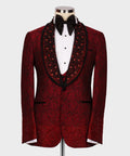 Front view of the luxurious Koss Atelier crimson red floral lace tuxedo jacket featuring a hand-beaded black shawl lapel and ombré crystal hem.