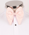 Men's oversized blush pink satin bow tie styled for prom and vintage wedding tuxedos.