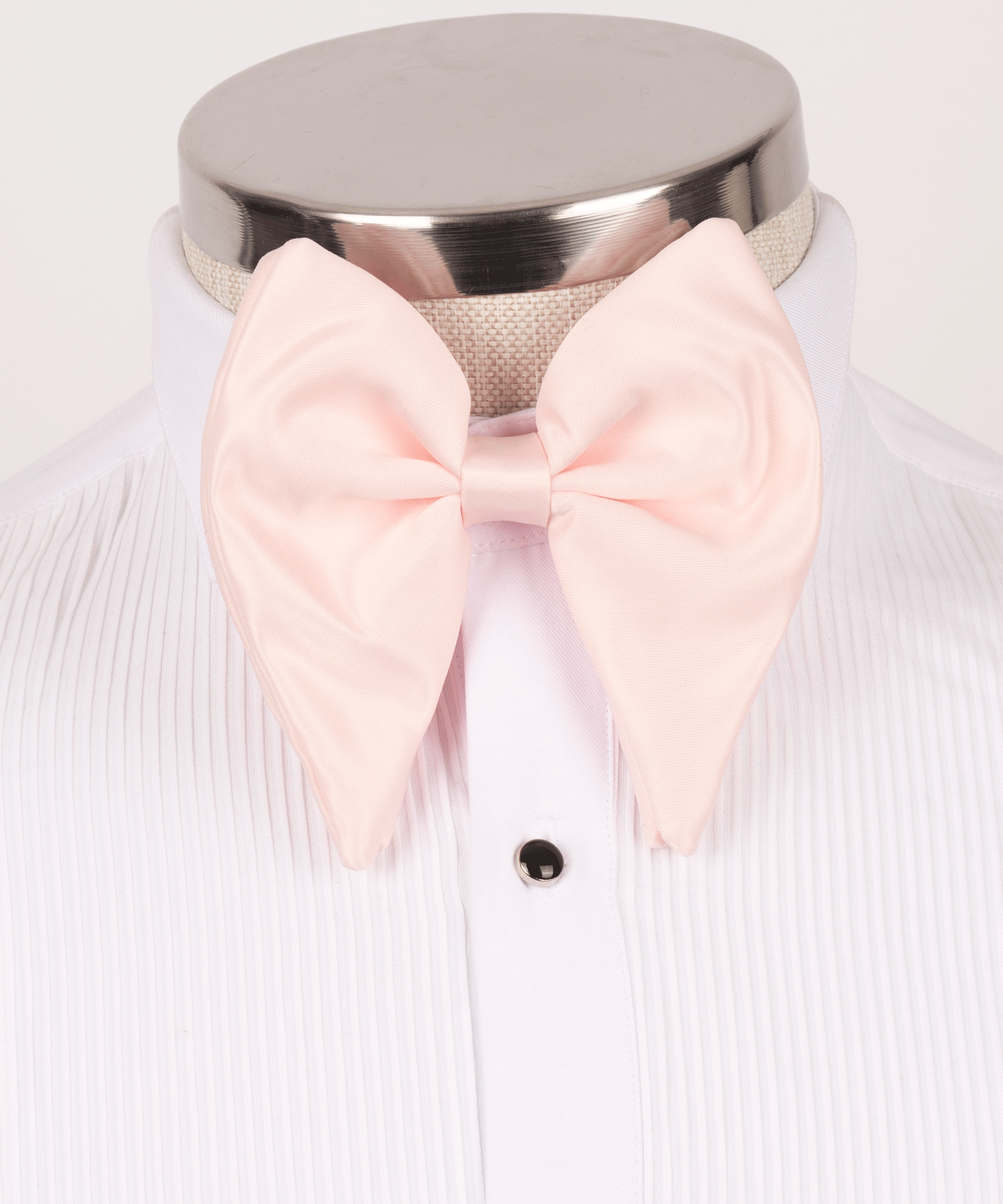 Men's oversized blush pink satin bow tie styled for prom and vintage wedding tuxedos.
