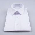 Close-up shot highlighting the high-thread-count vertical pleats and contrasting black hardware on a warm ivory tuxedo shirt.