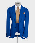 Blue suit jacket with vest, white shirt, gold patterned tie, pocket square
