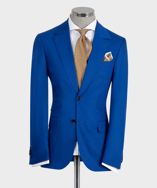 Blue suit jacket with matching vest and gold patterned tie on mannequin