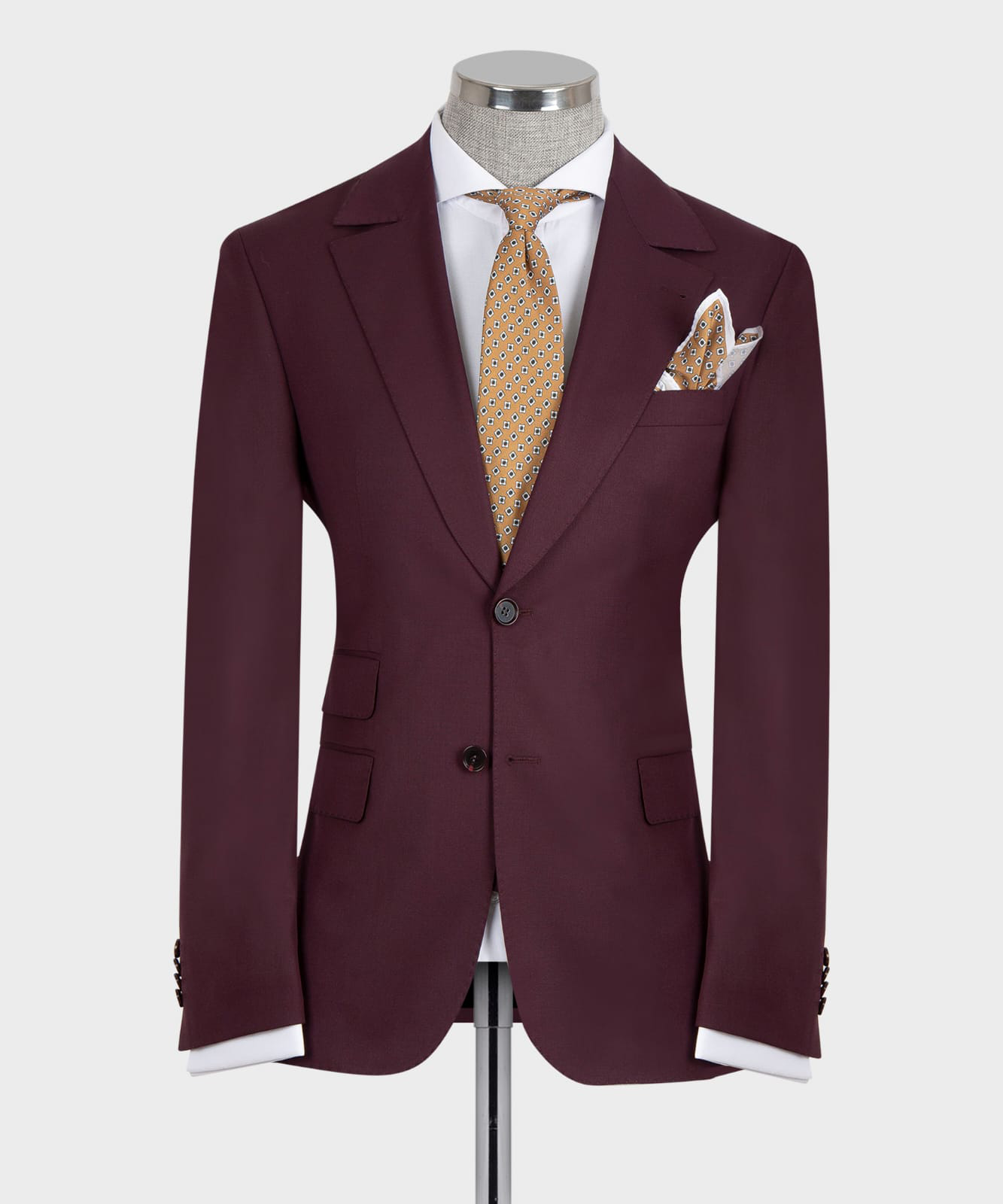 Burgundy three-piece suit jacket with vest, patterned gold tie, and matching pocket square